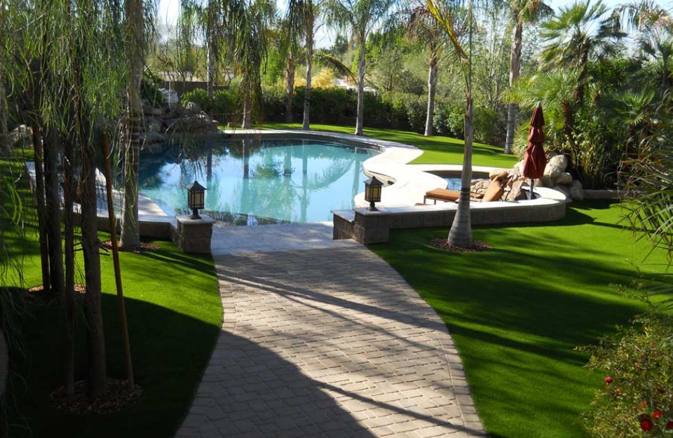 Artificial Grass around a pool in backyard of Phoenix homeowner
